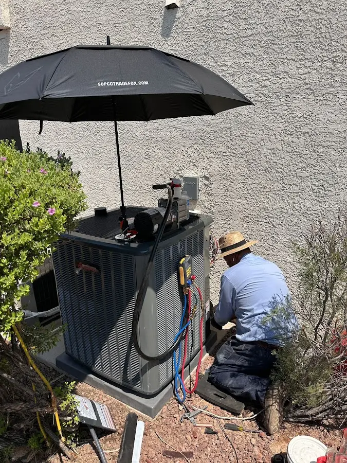 HVAC technician performing outdoor AC maintenance in Country Walk