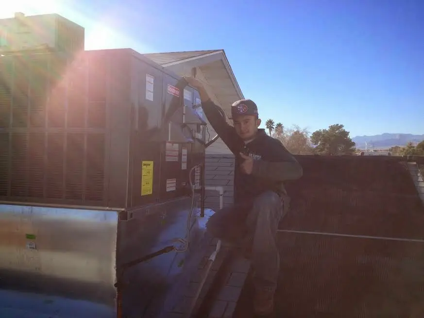 HVAC technician performing HVAC Inspection on a rooftop unit in Country Walk